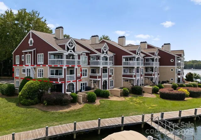 a front view of a house with a yard and potted plants
