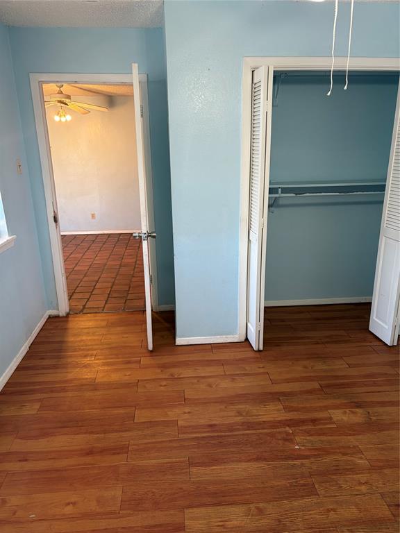 13360 Southview Lane Dallas, TX 75240 - Photo 18 of 26 an empty room with wooden floor and a window