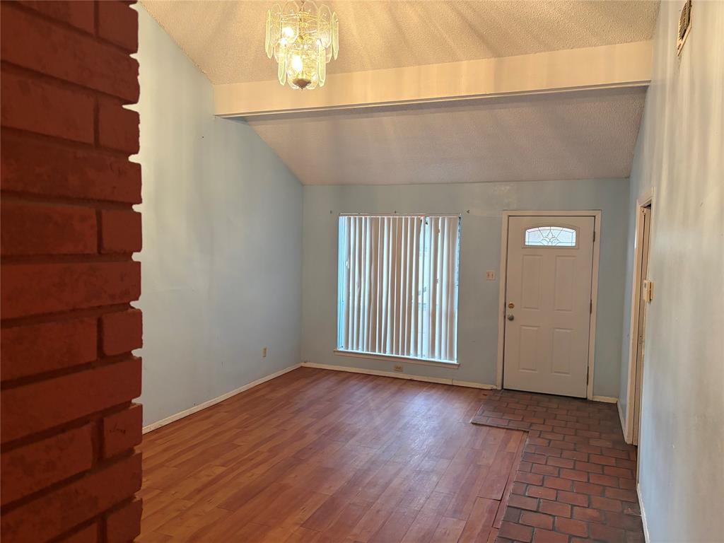 13360 Southview Lane Dallas, TX 75240 - Photo 2 of 26 an empty room with wooden floor and windows