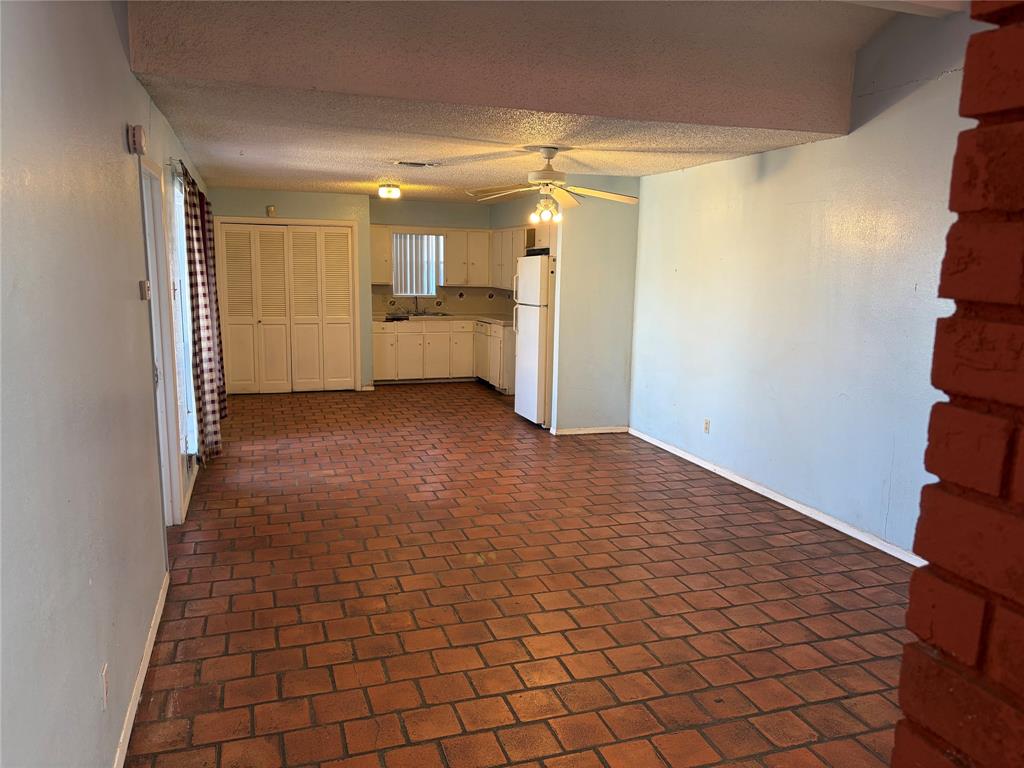 13360 Southview Lane Dallas, TX 75240 - Photo 5 of 26 a view of a hallway with wooden floor and a cabinet