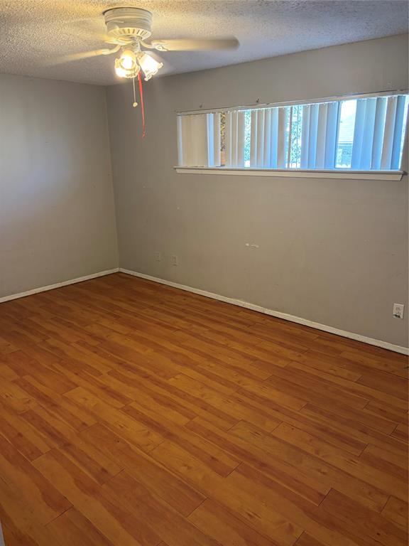 13360 Southview Lane Dallas, TX 75240 - Photo 9 of 26 a view of an empty room with wooden floor and a window
