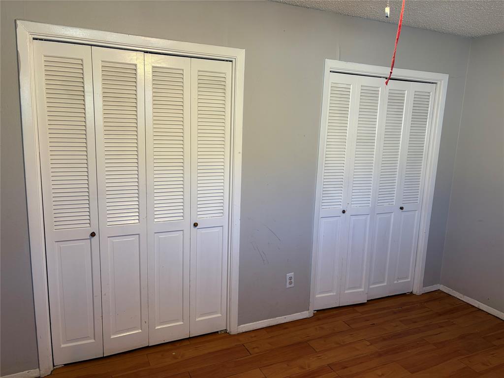 13360 Southview Lane Dallas, TX 75240 - Photo 10 of 26 a view of an empty room with wooden floor and a window