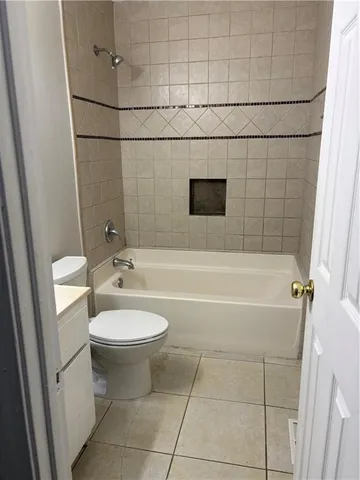 a bathroom with a toilet a sink and bathtub