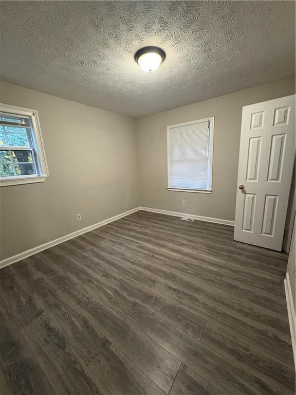 657 Utoy Court Jonesboro, GA 30238 - Photo 18 of 29 an empty room with wooden floor and windows