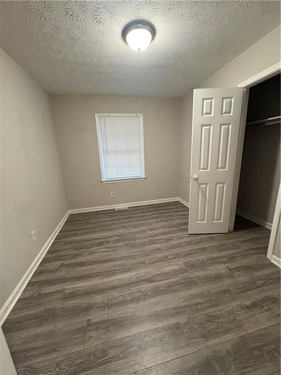 657 Utoy Court Jonesboro, GA 30238 - Photo 19 of 29 an empty room with wooden floor and windows