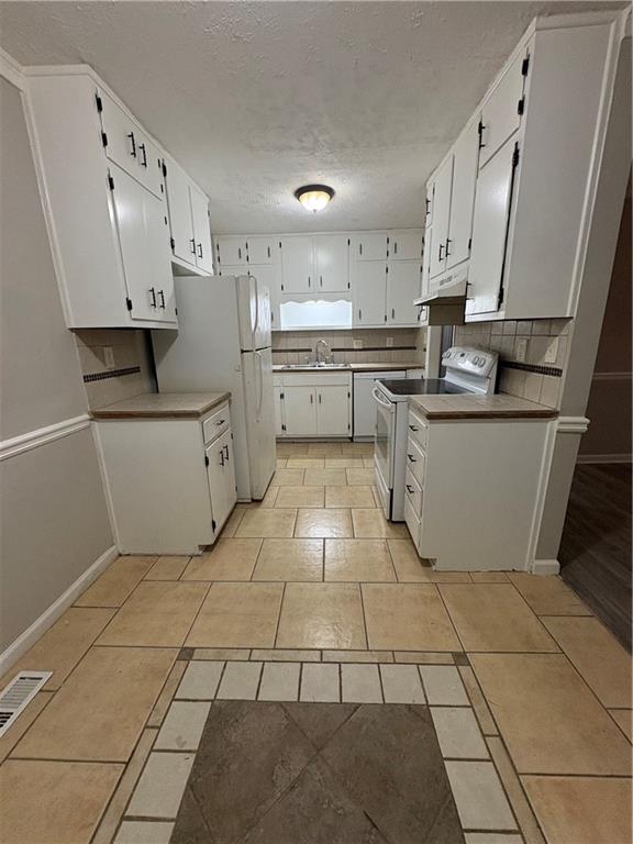 657 Utoy Court Jonesboro, GA 30238 - Photo 21 of 29 a kitchen with stainless steel appliances cabinets a sink and a stove