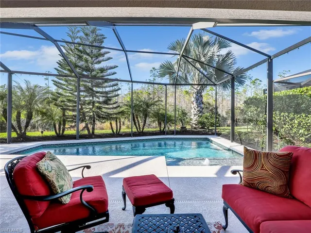 a living room filled with furniture and a potted plant