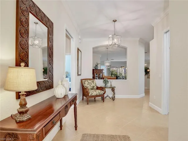 a living room with furniture and a mirror