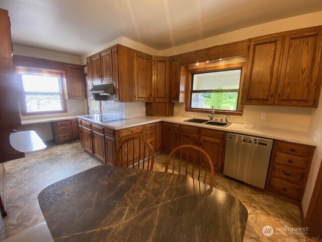 0 East Badger Road Lynden, WA 98264 - Photo 28 of 34 a kitchen with stainless steel appliances granite countertop a sink a stove and a wooden cabinets