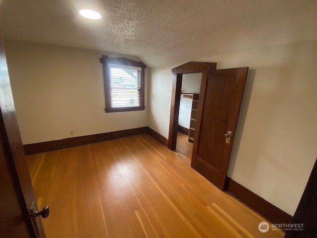 0 East Badger Road Lynden, WA 98264 - Photo 31 of 34 a view of an empty room with wooden floor and a window