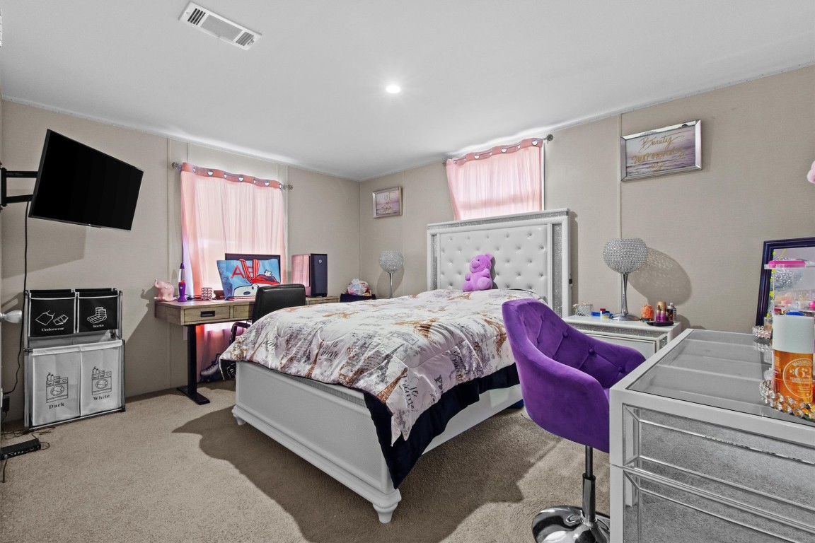 480 Grandpa Road Lockhart, TX 78644 - Photo 13 of 32 a bed room with a bed a flat screen tv and windows