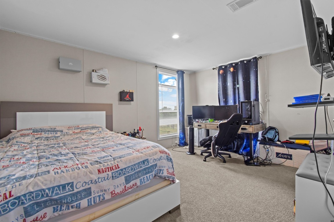 480 Grandpa Road Lockhart, TX 78644 - Photo 15 of 32 a bedroom with a bed and a tv on table