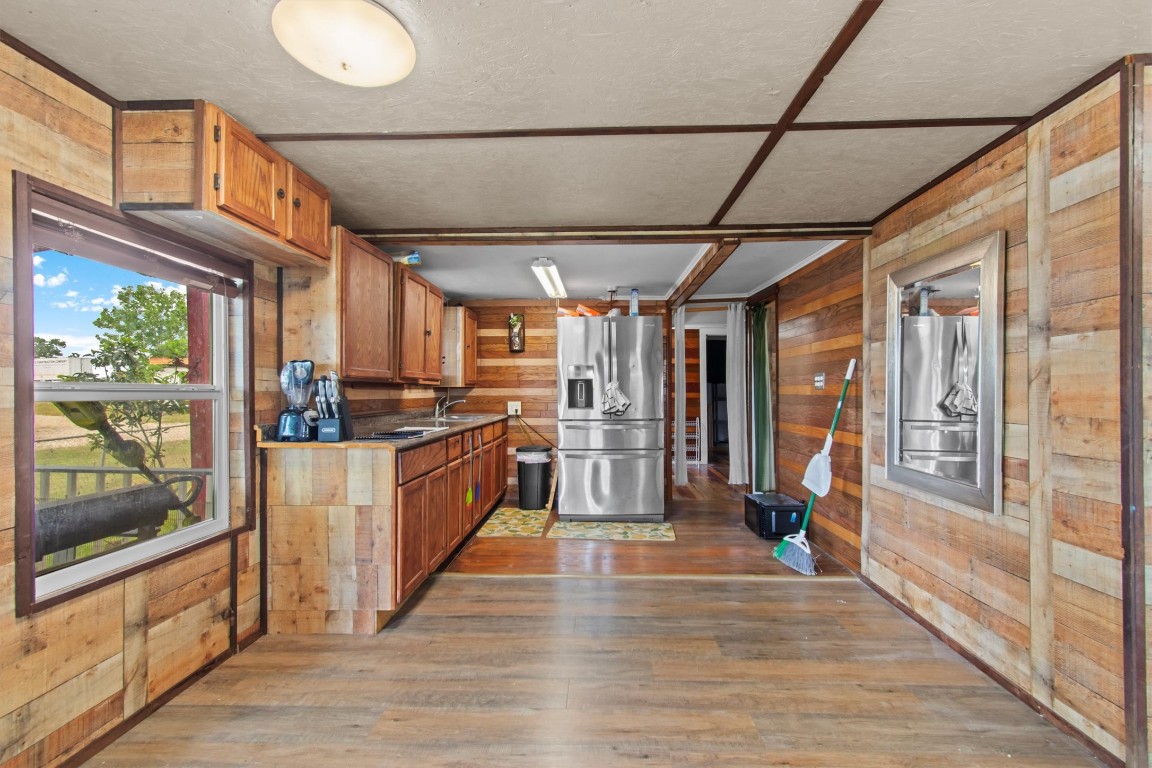 480 Grandpa Road Lockhart, TX 78644 - Photo 21 of 32 a kitchen with stainless steel appliances granite countertop a stove and wooden cabinets
