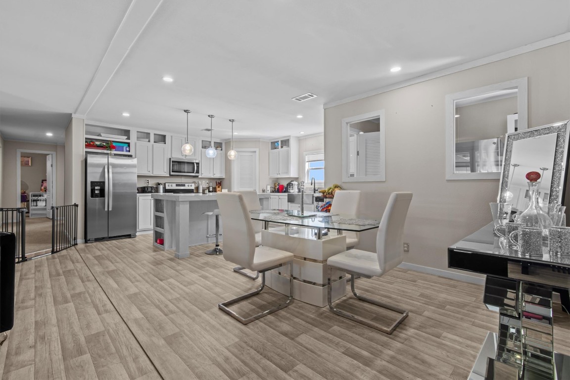 480 Grandpa Road Lockhart, TX 78644 - Photo 5 of 32 a living room with stainless steel appliances kitchen island granite countertop furniture wooden floor and a view of kitchen