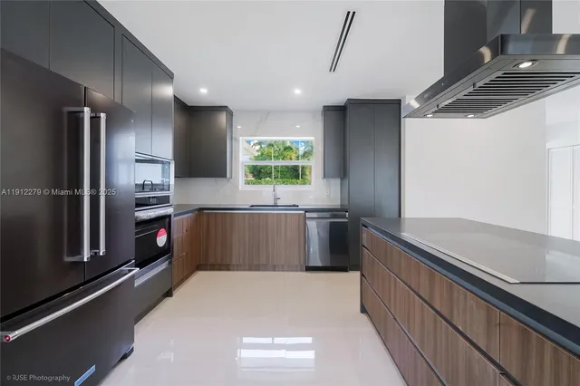 a kitchen with stainless steel appliances a refrigerator and a sink