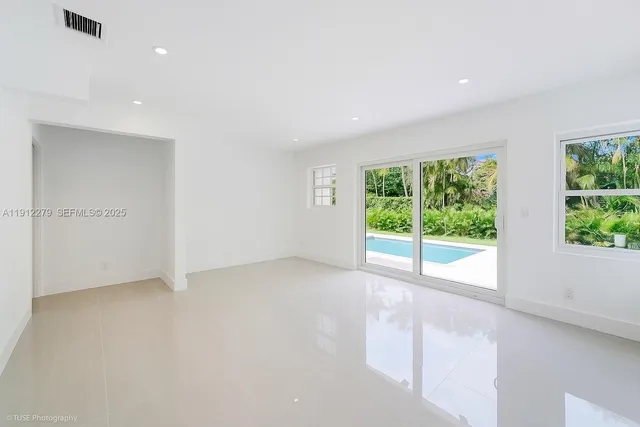 a large bedroom with a large bed and a large window