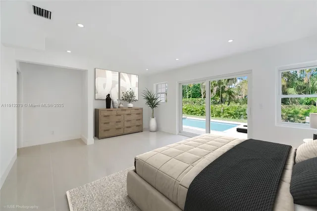 a large bedroom with a large bed and a large window