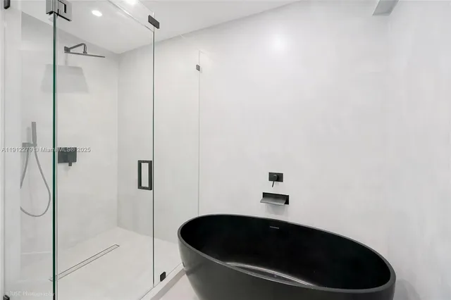 a bathroom with a bathtub and shower