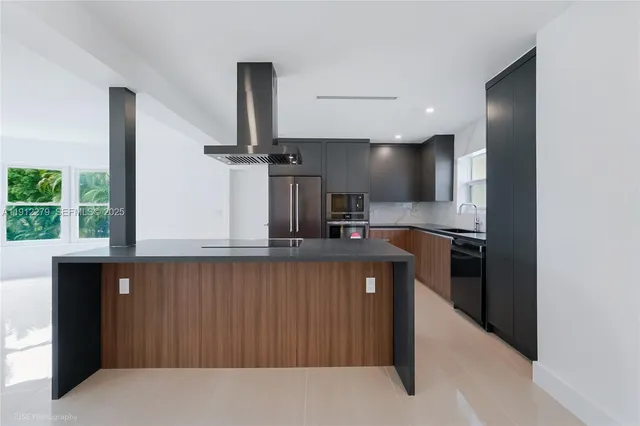 a kitchen with stainless steel appliances a sink and a refrigerator