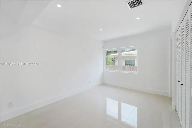 a bedroom with bed and a window