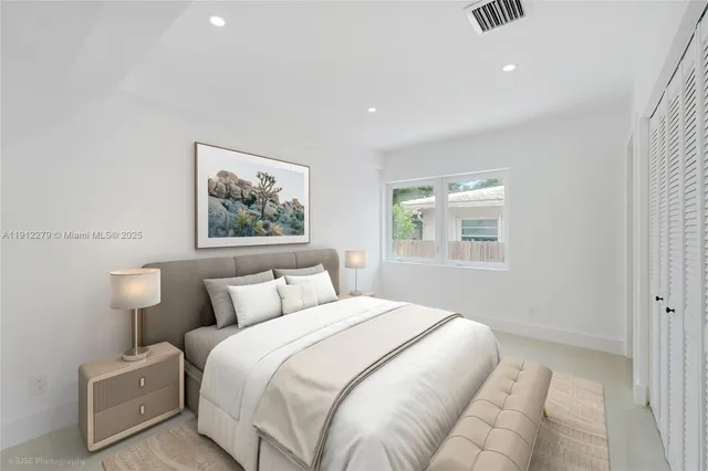 a bedroom with bed and a window