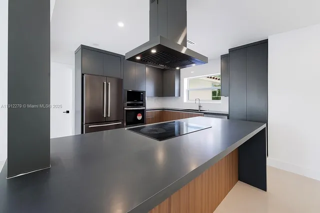 a kitchen with stainless steel appliances a sink a stove and a refrigerator