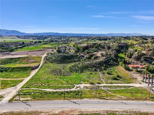 an aerial view of a golf course with a lake view