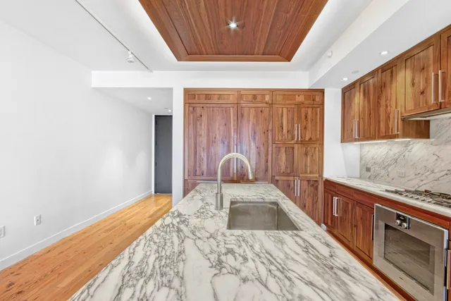 a kitchen with granite countertop cabinets and wooden floor