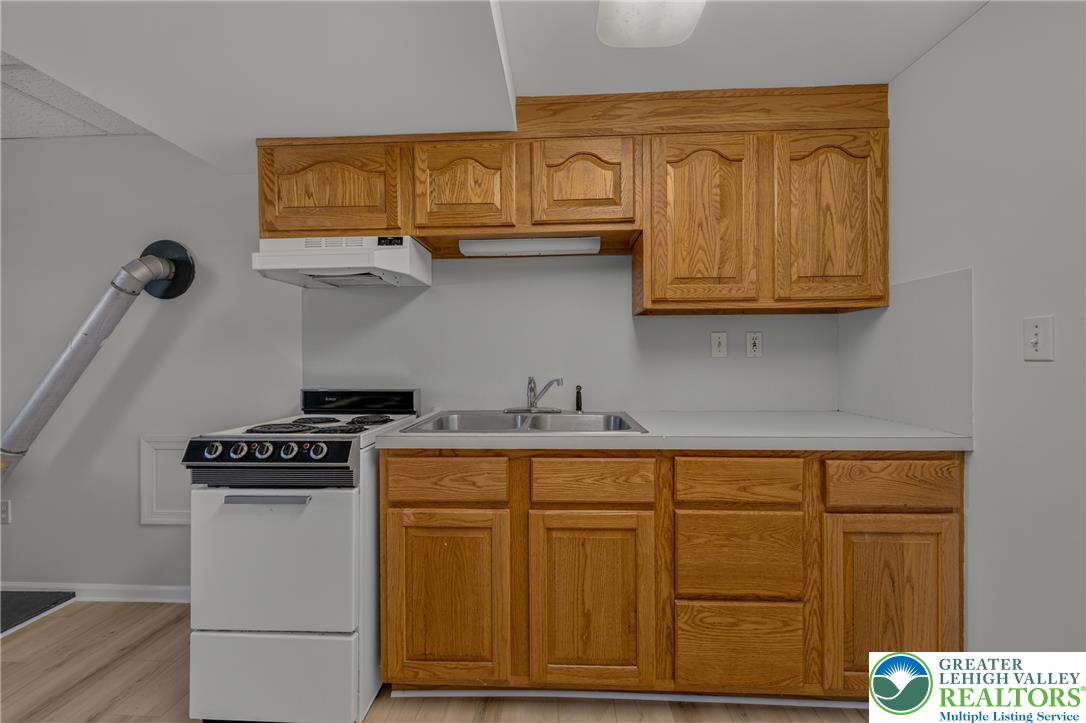 630 Clearfield Road Nazareth, PA 18064 - Photo 76 of 100 Classic oak cabinetry and laminate countertops define this functional lower level kitchenette space.