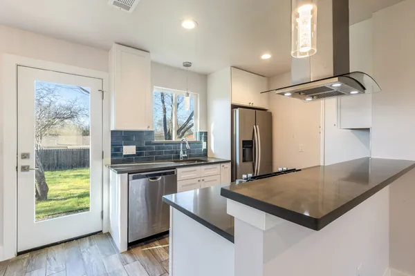 a kitchen with kitchen island a counter top space appliances and a counter top space