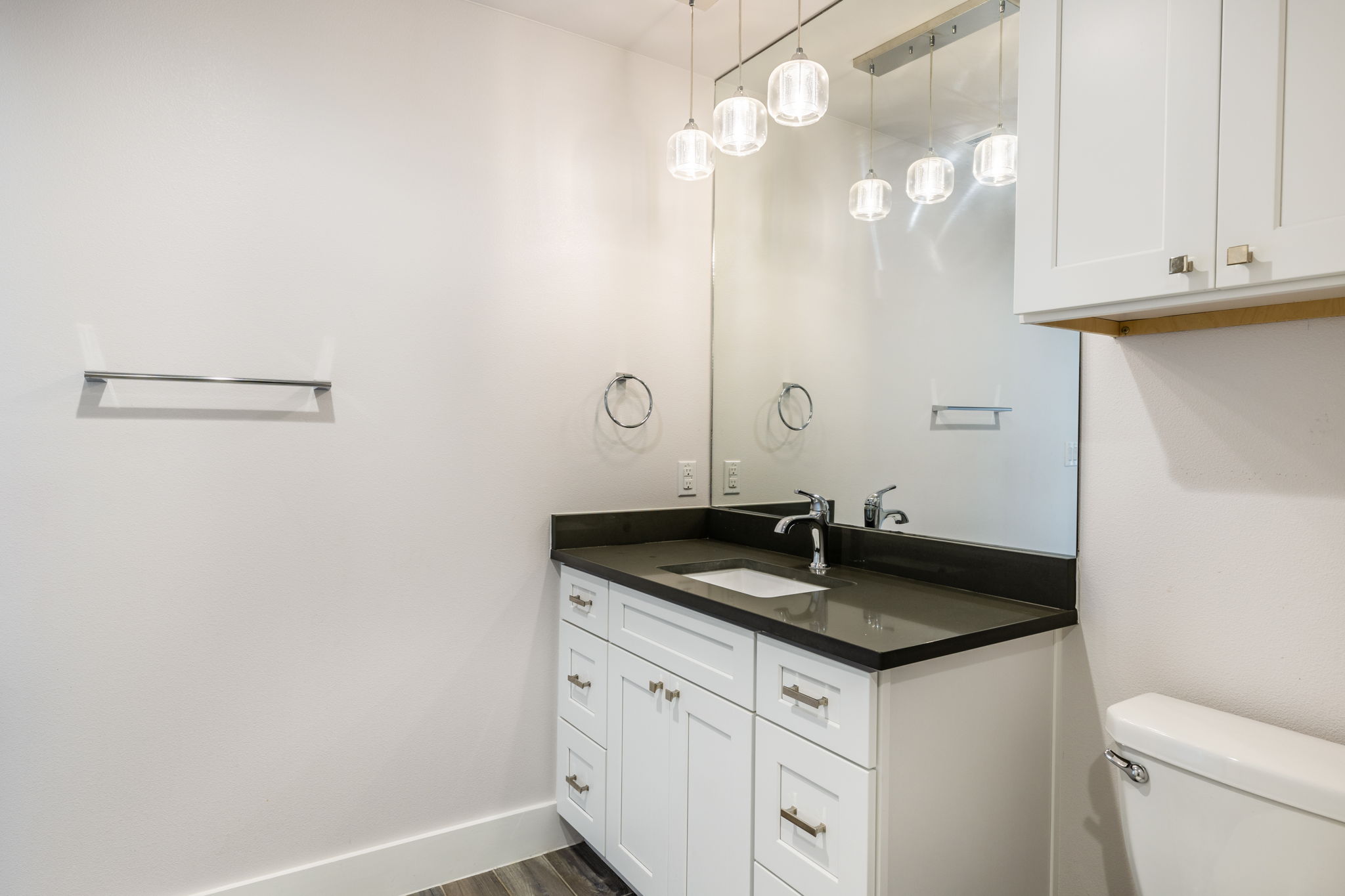 8410 Romney Road Austin, TX 78748 - Photo 17 of 35 Half bath with vanity and dark wood-type flooring