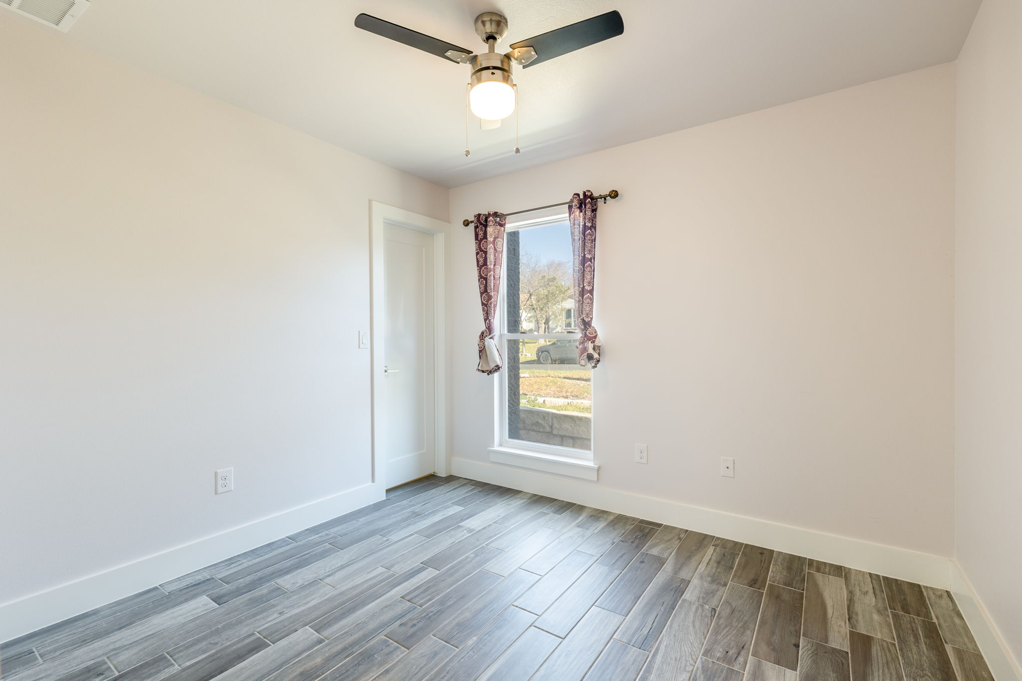 8410 Romney Road Austin, TX 78748 - Photo 21 of 35 Unfurnished room with wood finish floors and a ceiling fan