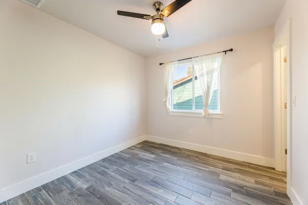 wooden floor in an empty room with a window