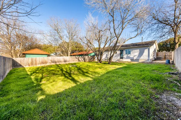 a view of backyard with swimming pool