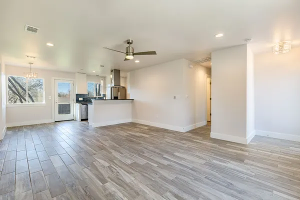 a view of a kitchen with a sink and wooden floor
