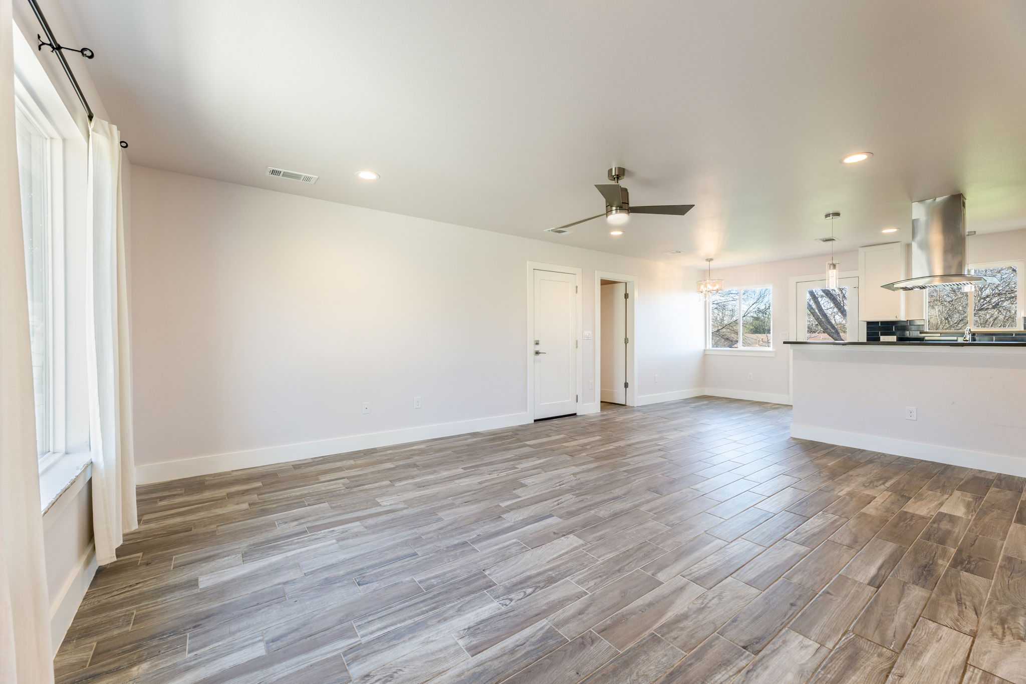 8410 Romney Road Austin, TX 78748 - Photo 6 of 35 Unfurnished living room with wood tiled floors, recessed lighting, and a ceiling fan