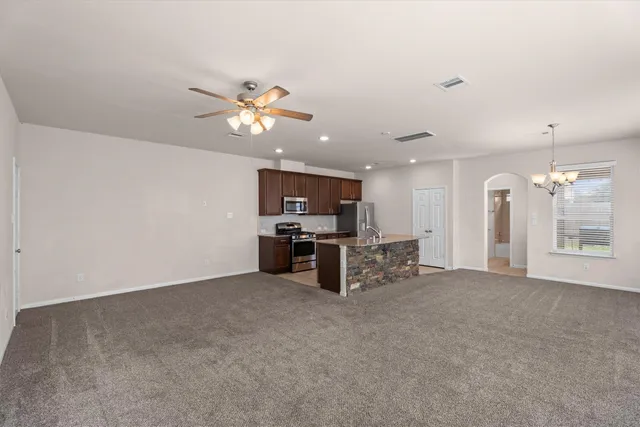 a view of a kitchen with furniture and a ceiling fan