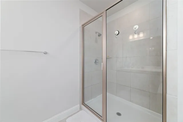 a bathroom with a glass shower door