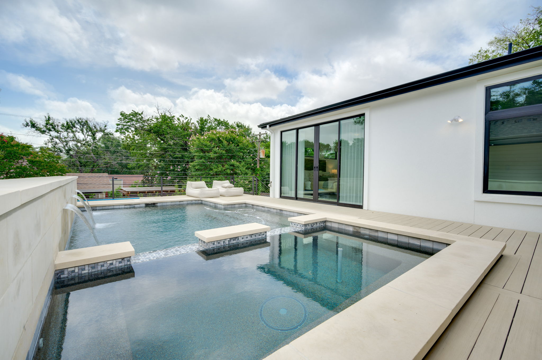 2415 McCall Road Austin, TX 78703 - Photo 37 of 40 An inviting private pool and spa area with a contemporary deck extends from the modern residence.