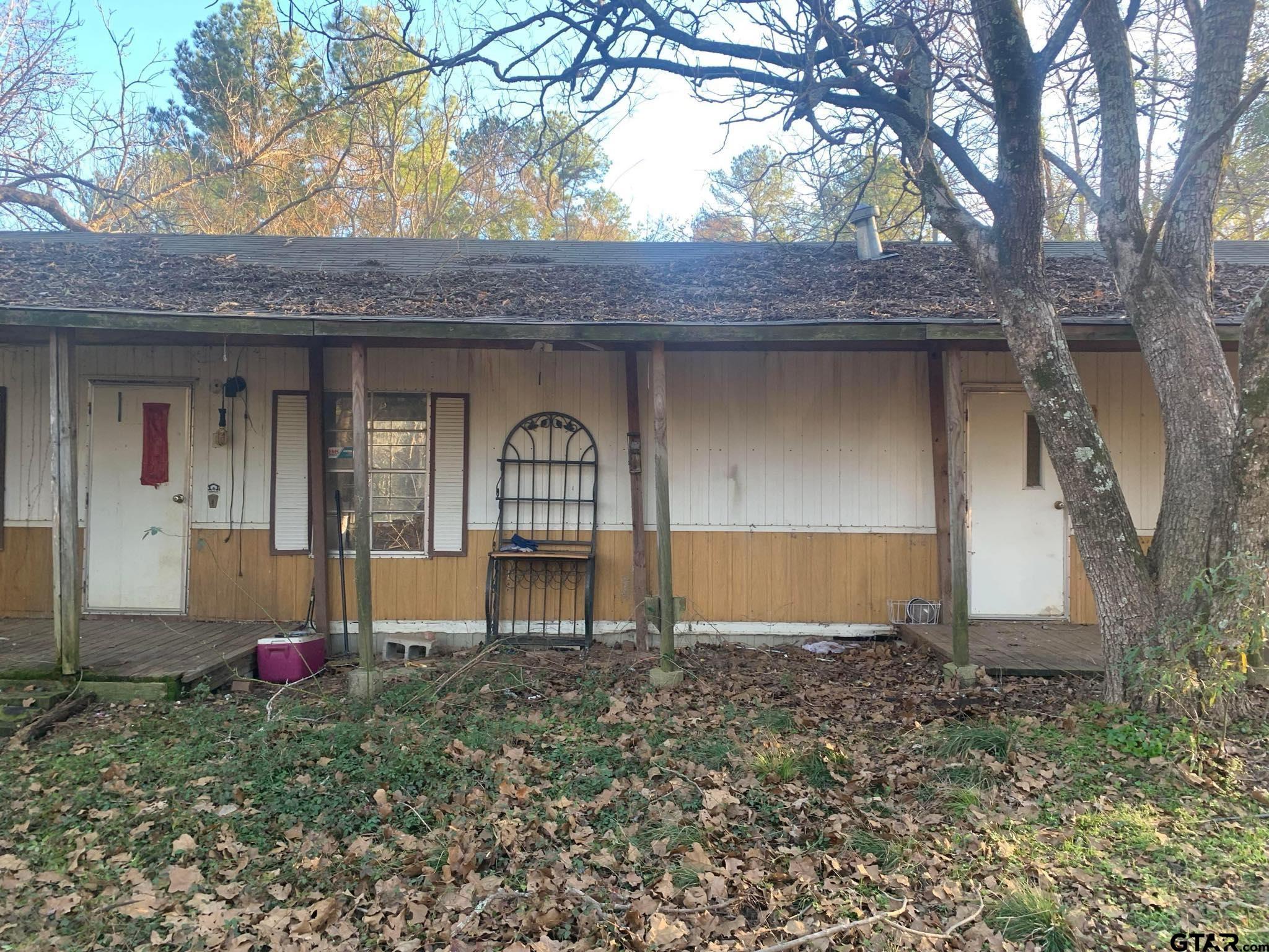 a view of a house with backyard and porch