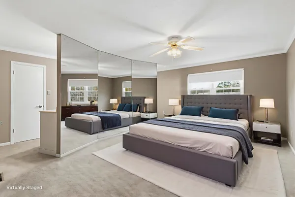 a spacious bedroom with two beds and a chandelier