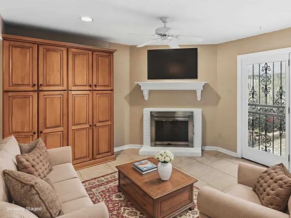 a view of an empty room with cabinet and a fireplace