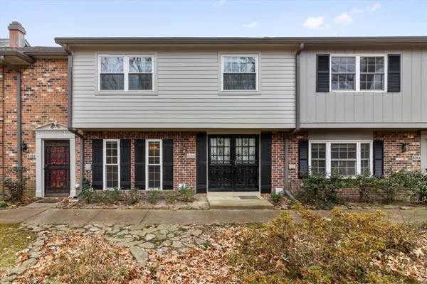 a view of a brick house with many windows