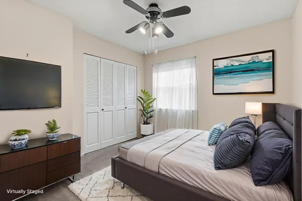 an empty room with windows and fan