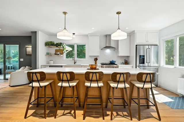 a dining room with furniture a chandelier and wooden floor