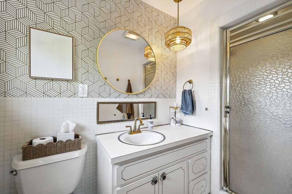 5 Yorkshire Road Marblehead, MA 01945 - Photo 17 of 37 a bathroom with a sink a mirror and a toilet