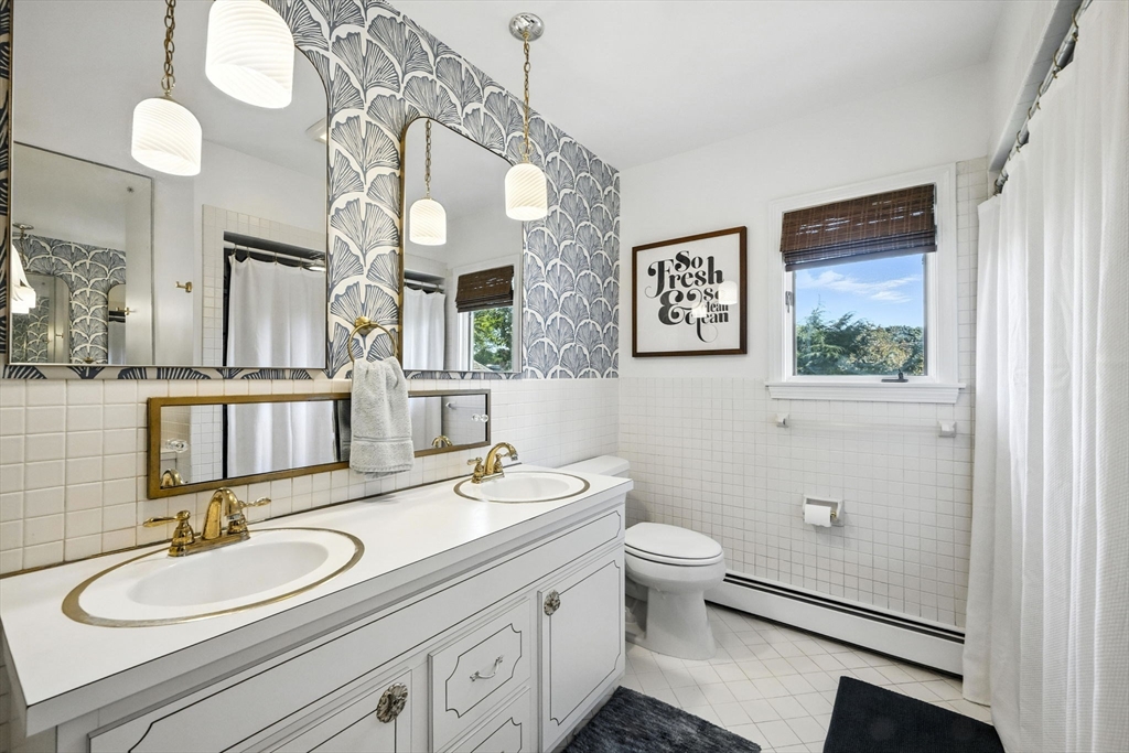 5 Yorkshire Road Marblehead, MA 01945 - Photo 21 of 37 a bathroom with a double vanity sink mirror and toilet