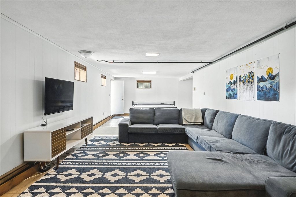 5 Yorkshire Road Marblehead, MA 01945 - Photo 25 of 37 a living room with furniture and a flat screen tv
