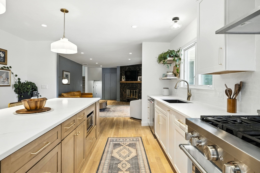 5 Yorkshire Road Marblehead, MA 01945 - Photo 3 of 37 a kitchen with stainless steel appliances granite countertop a sink a stove and a wooden floors