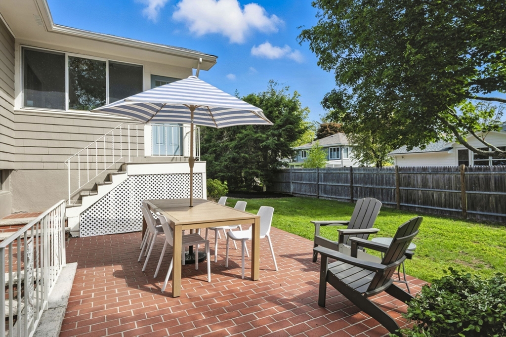 5 Yorkshire Road Marblehead, MA 01945 - Photo 34 of 37 a view of a chairs and table in the back yard of the house